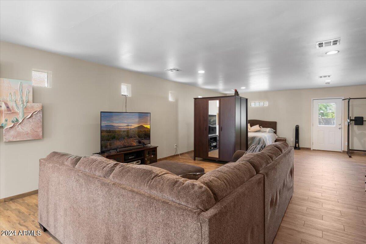 1706 West Parsons Road Phoenix, AZ 85085 - Photo 55 of 58 a living room with furniture and a flat screen tv