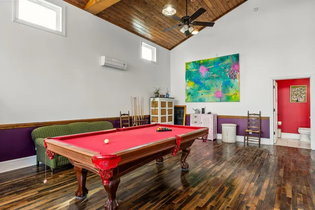 a room with furniture and pool table