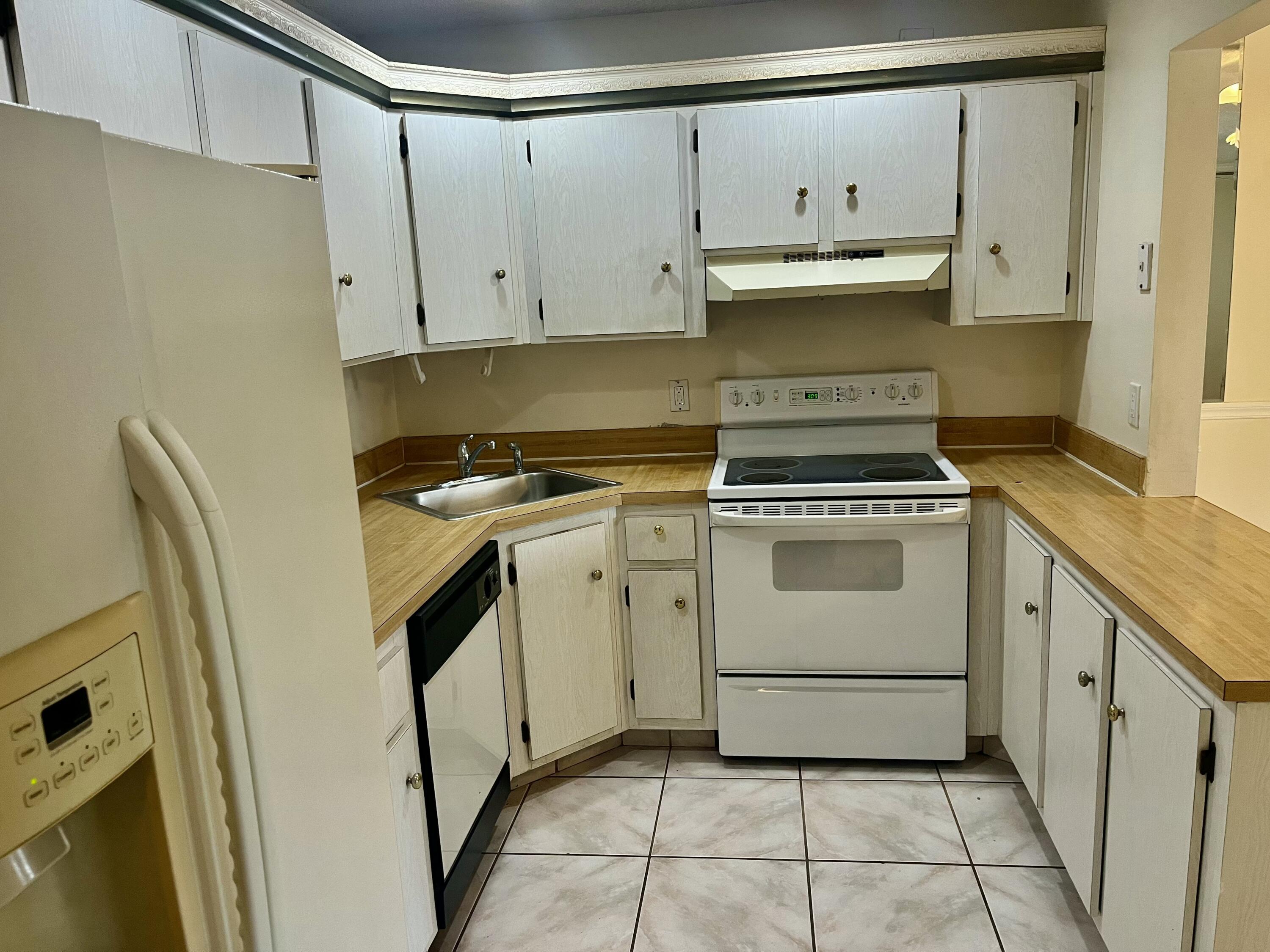 536 Shady Pine Way, Unit C2 Greenacres, FL 33415 - Photo 13 of 28 a kitchen with a stove top oven sink and cabinets