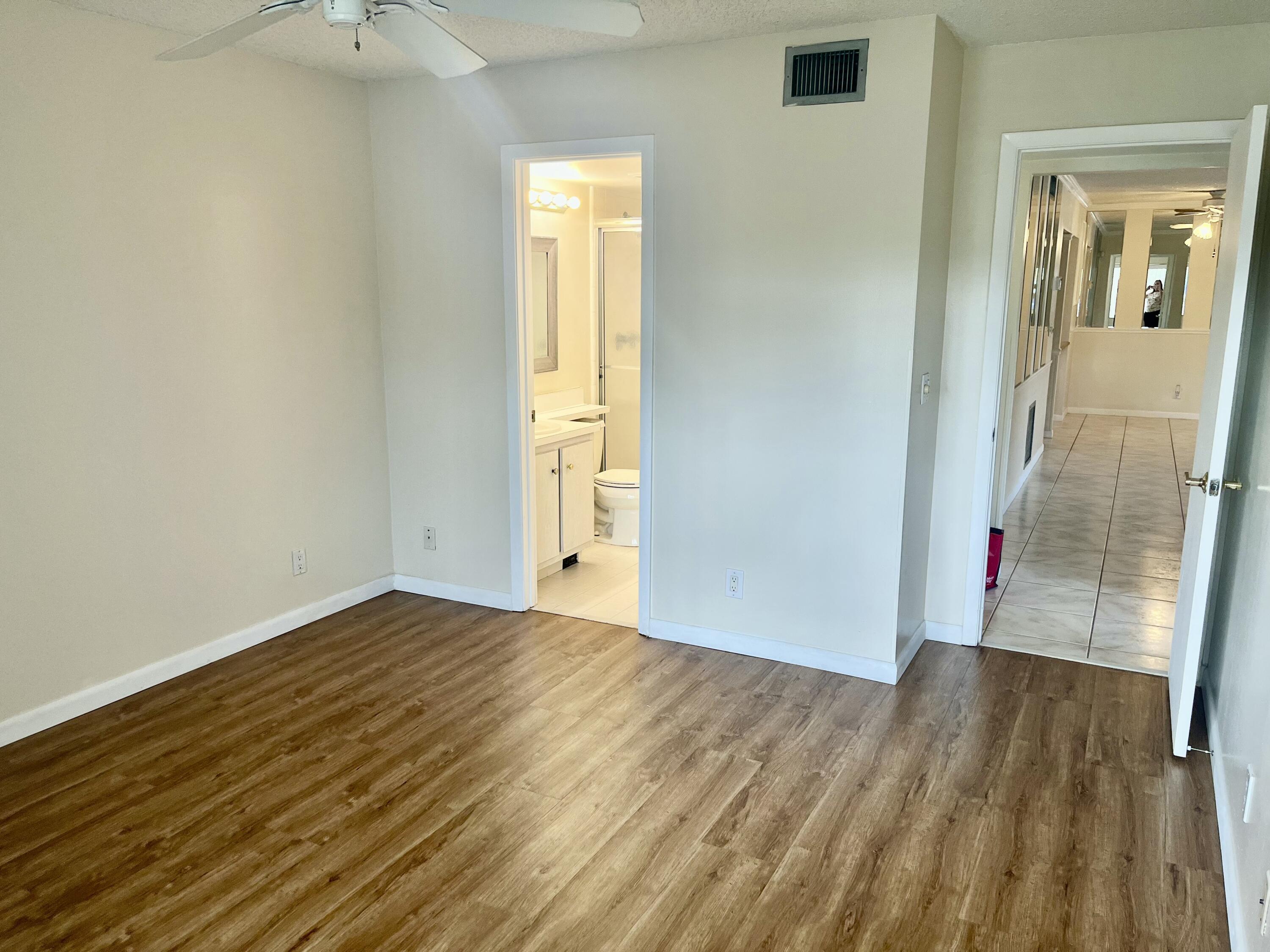 536 Shady Pine Way, Unit C2 Greenacres, FL 33415 - Photo 16 of 28 a view of a hallway with wooden floor and a bathroom