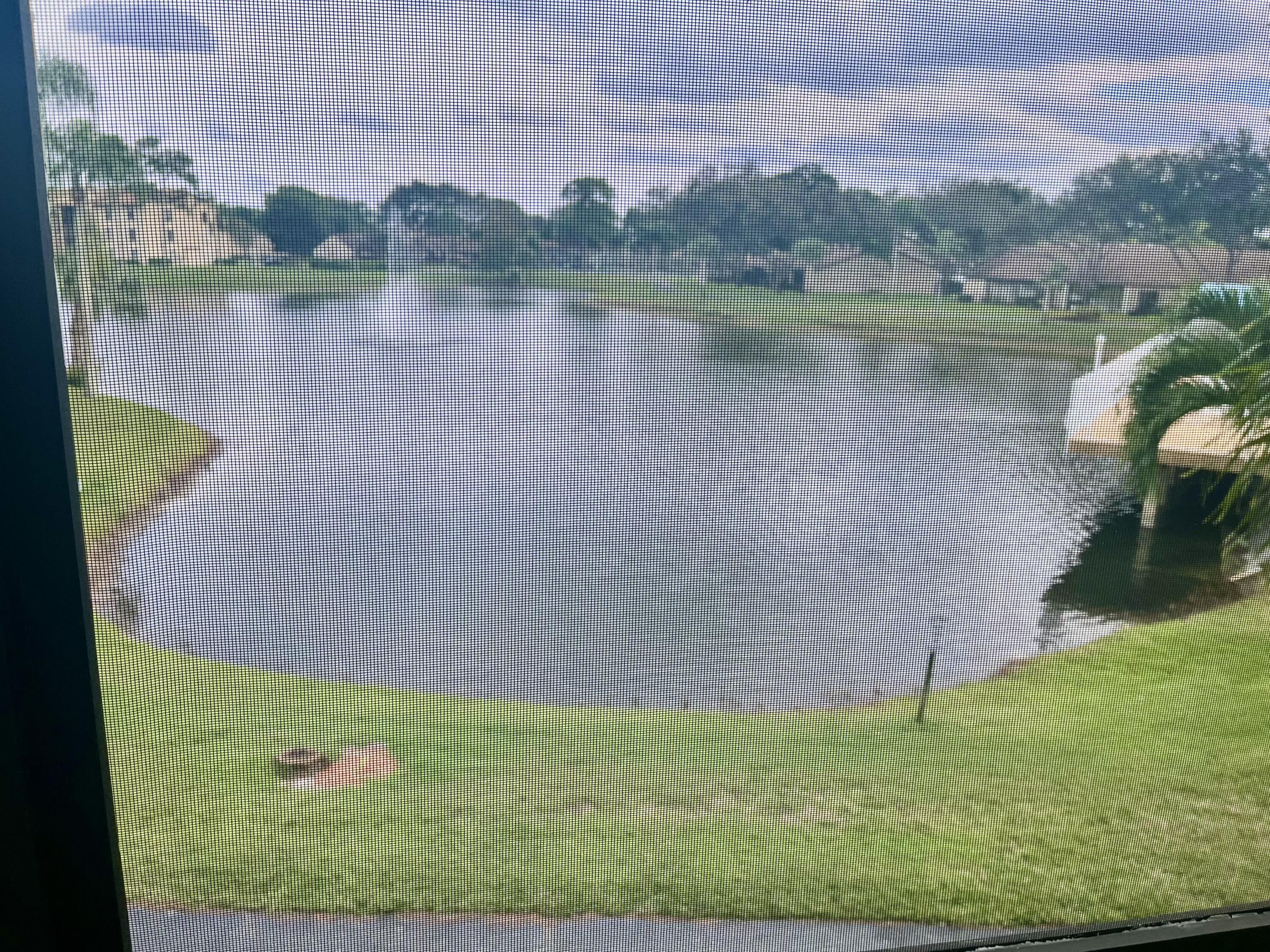 536 Shady Pine Way, Unit C2 Greenacres, FL 33415 - Photo 27 of 28 a view of a lake from a yard