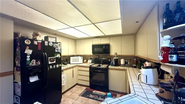 a kitchen with a sink appliances and cabinets