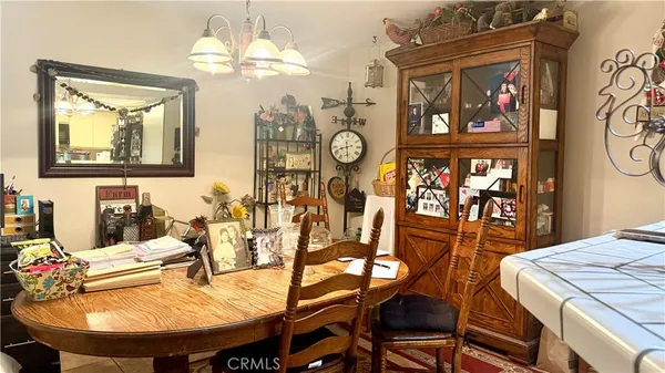 a view of a dining room with furniture and chandelier