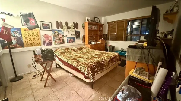 a bed sitting in a room next to a window
