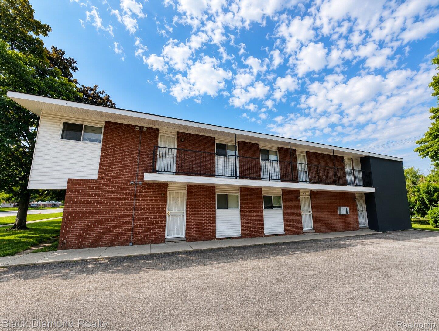 16217 Greenfield Road Detroit, MI 48235 - Photo 2 of 16 Two-story building featuring brick and white horizontal siding