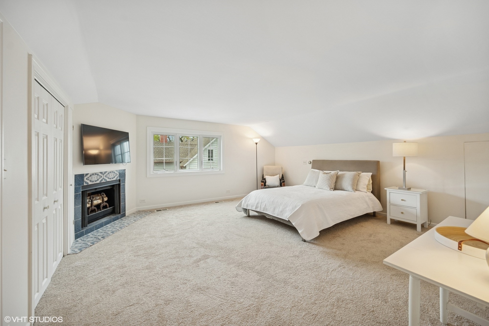 770 Prospect Avenue Winnetka, IL 60093 - Photo 30 of 50 a spacious bedroom with a bed and a fireplace