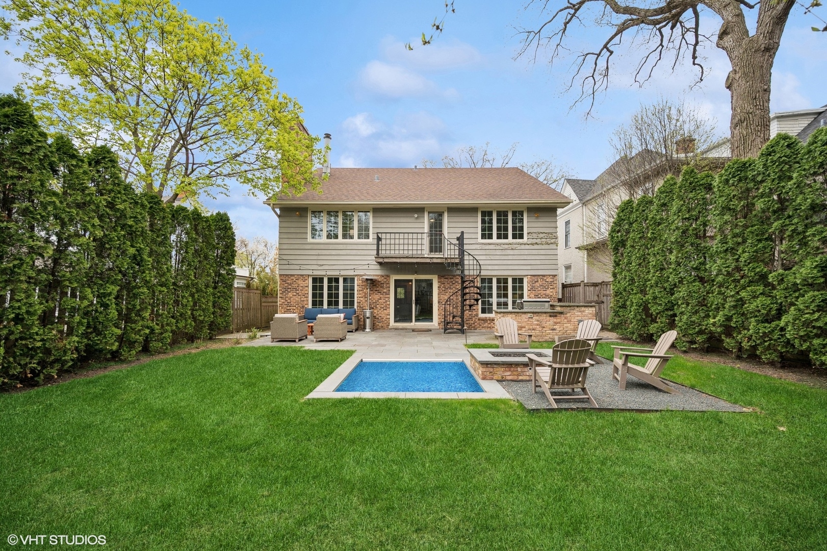 770 Prospect Avenue Winnetka, IL 60093 - Photo 36 of 50 a front view of a house with a yard table and chairs