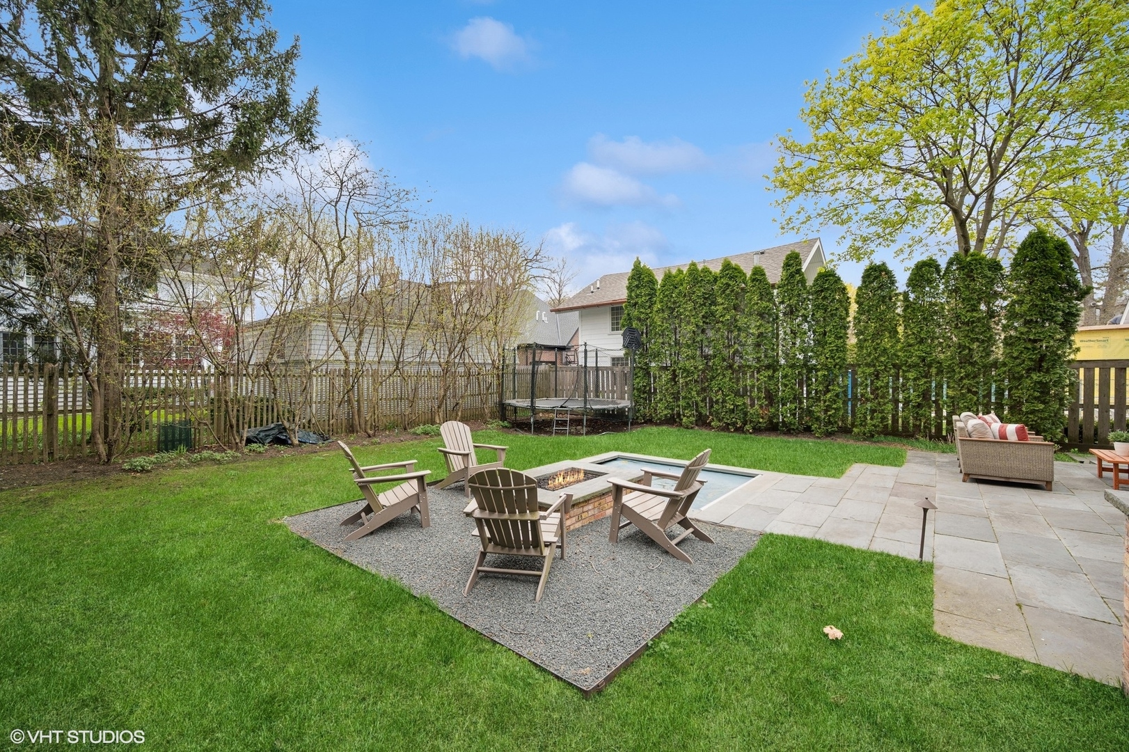 770 Prospect Avenue Winnetka, IL 60093 - Photo 40 of 50 a chair and table sitting in the grass near a house
