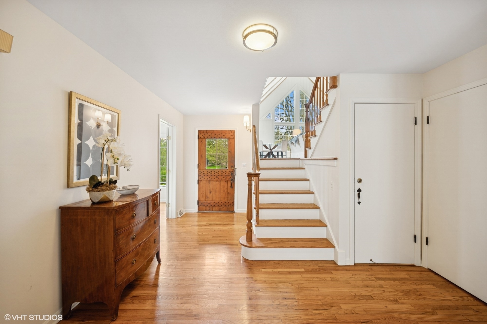 770 Prospect Avenue Winnetka, IL 60093 - Photo 4 of 50 a view of a hallway with wooden floor and staircase
