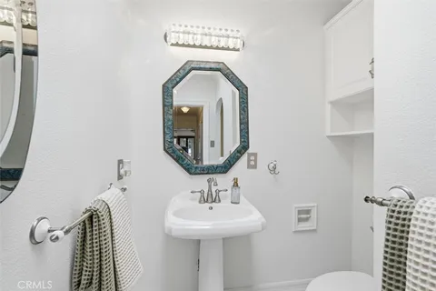 a bathroom with a toilet a sink and mirror