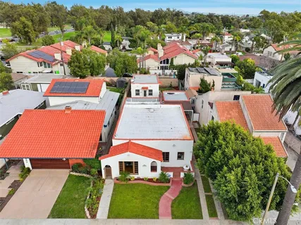 an aerial view of multiple houses with a yard