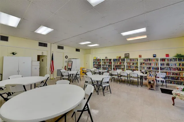 a view of a room with lots of tables and chairs