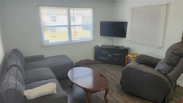 a view of a dining room with furniture and wooden floor