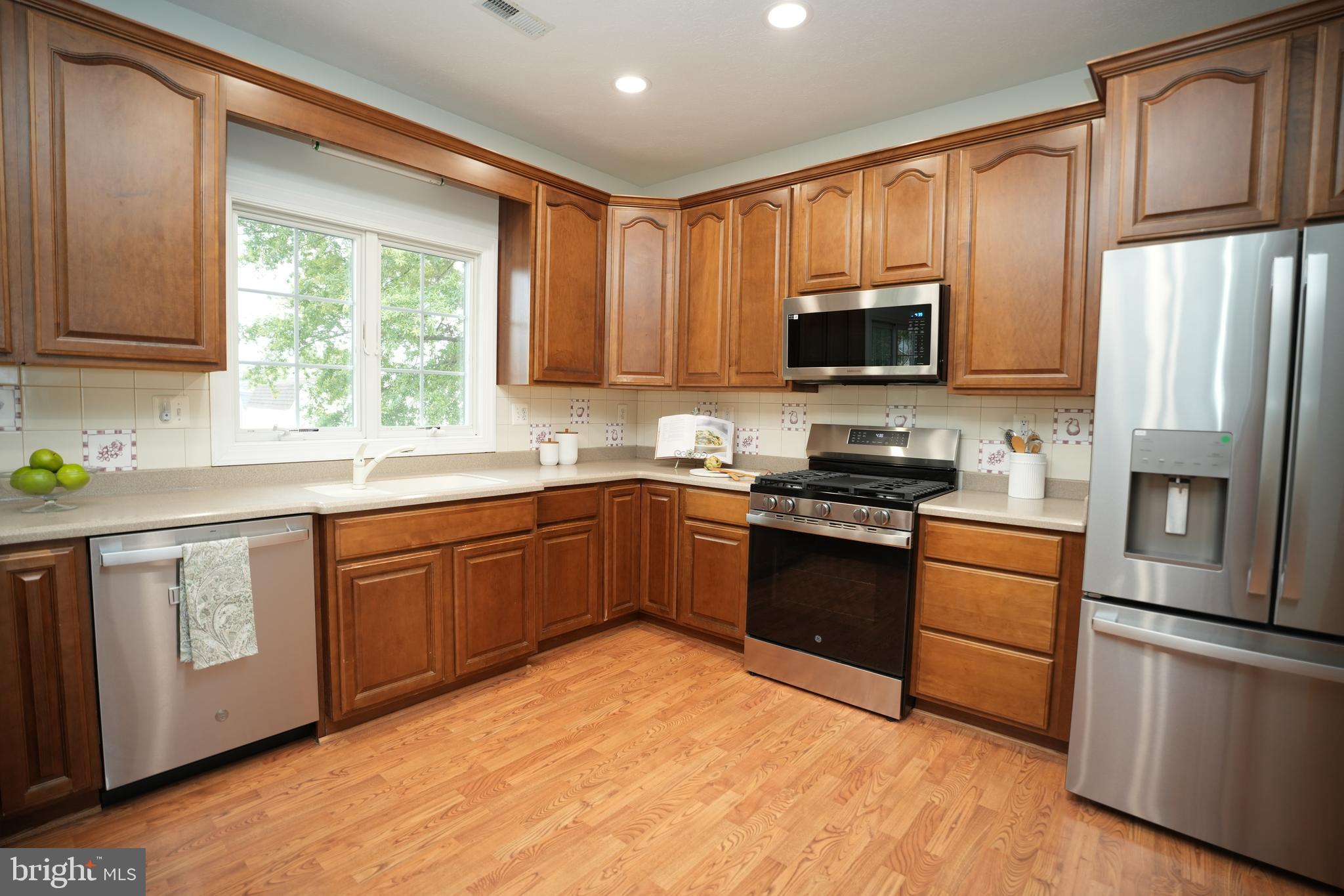 16460 Sayre Point Lane Piney Point, MD 20674 - Photo 22 of 61 a kitchen with stainless steel appliances granite countertop a refrigerator stove microwave and sink
