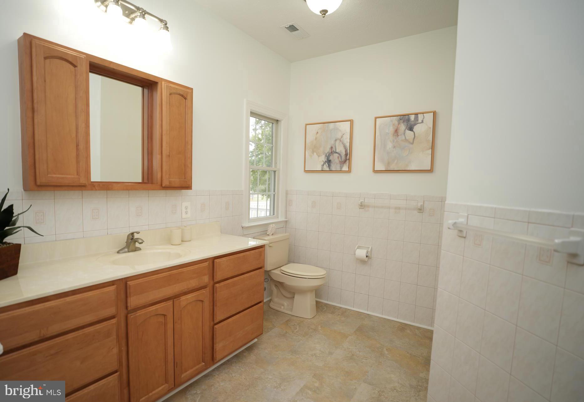 16460 Sayre Point Lane Piney Point, MD 20674 - Photo 30 of 61 a bathroom with a toilet sink and mirror