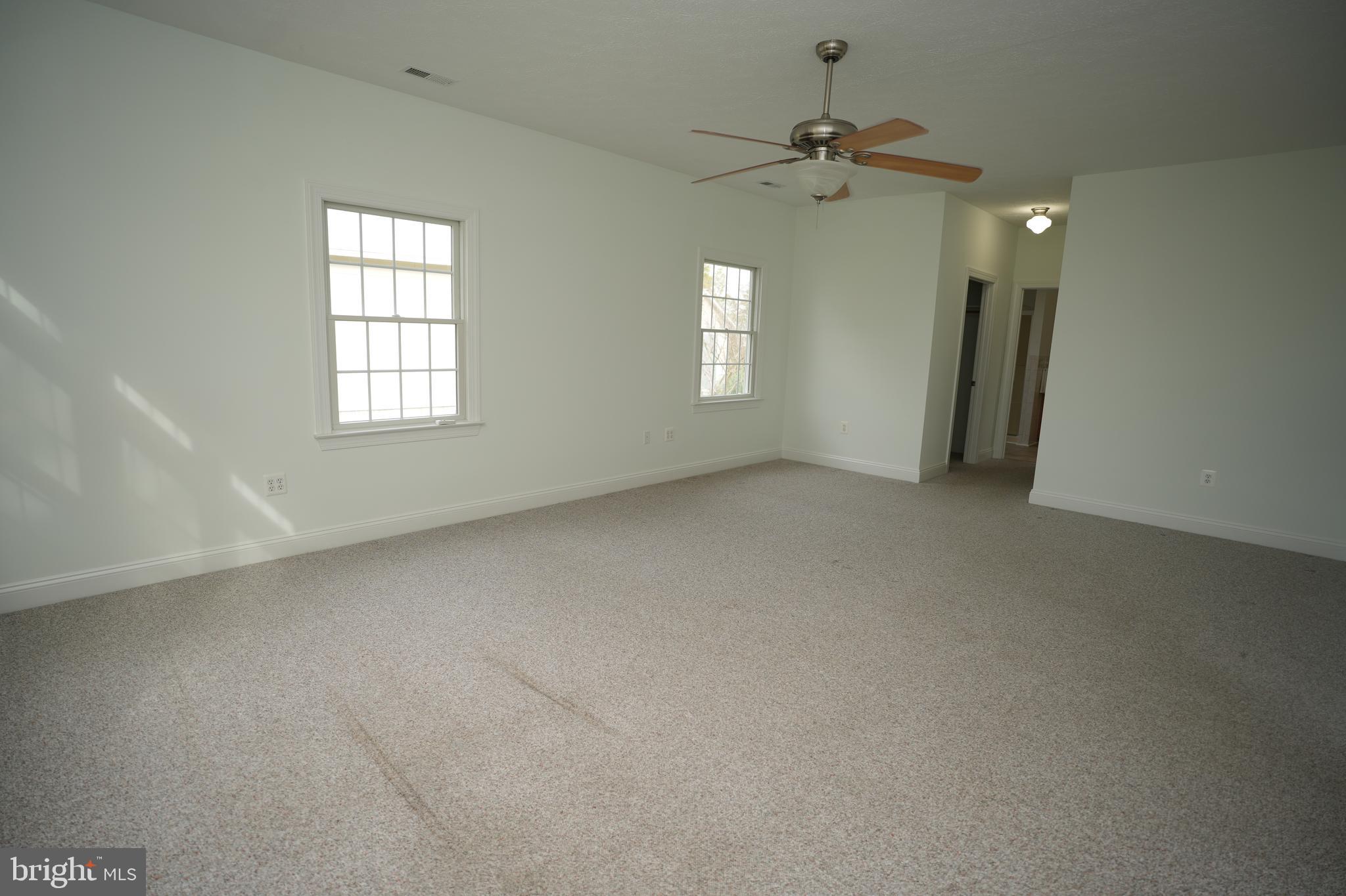 16460 Sayre Point Lane Piney Point, MD 20674 - Photo 33 of 61 an empty room with a window and a ceiling fan