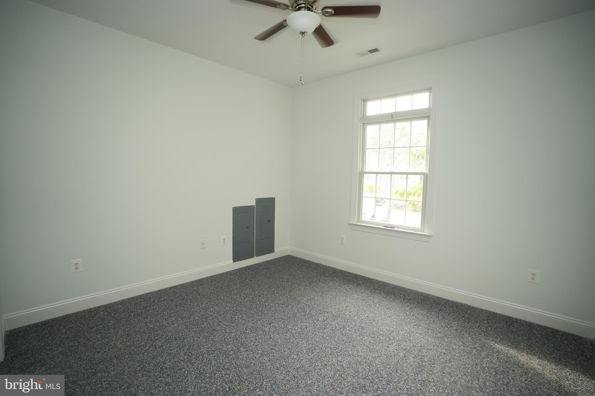 16460 Sayre Point Lane Piney Point, MD 20674 - Photo 36 of 61 an empty room with a ceiling fan and window