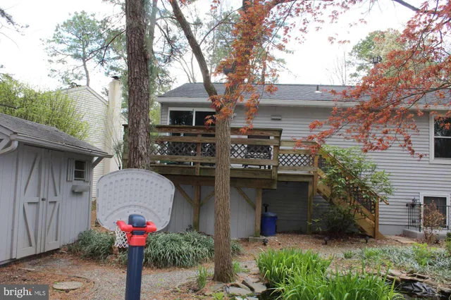 a front view of house with yard and trees