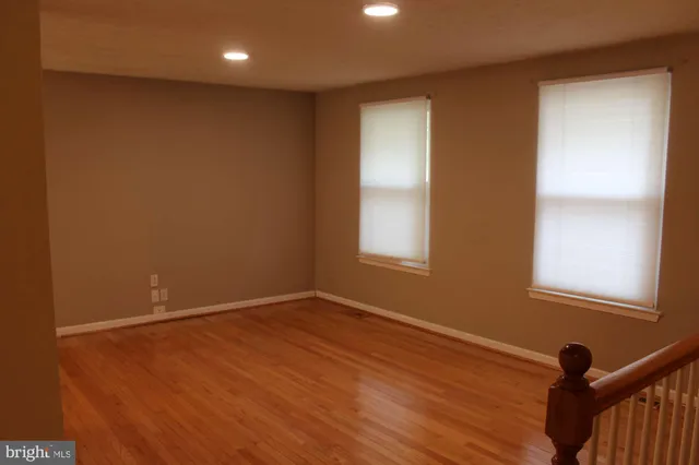 a view of a room with wooden floor and outdoor view