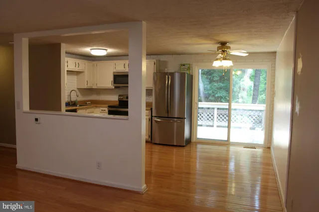 a view of an empty room with wooden floor