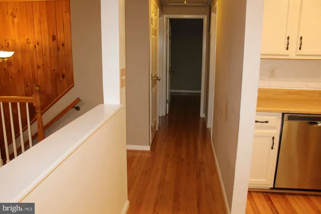 a view of a room with wooden floor