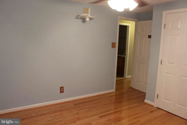 a view of a room with wooden floor and a chandelier