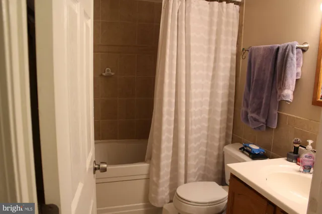an empty room with wooden floor and a window