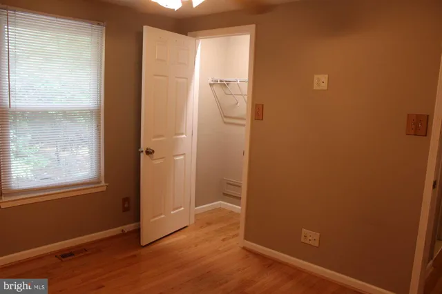 a view of room with window and hardwood floor