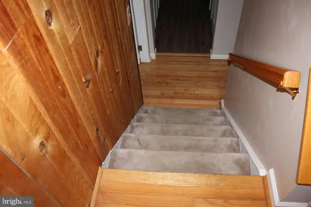 a view of room with wooden floor and fan