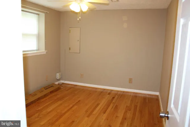 an empty room with wooden floor and closet