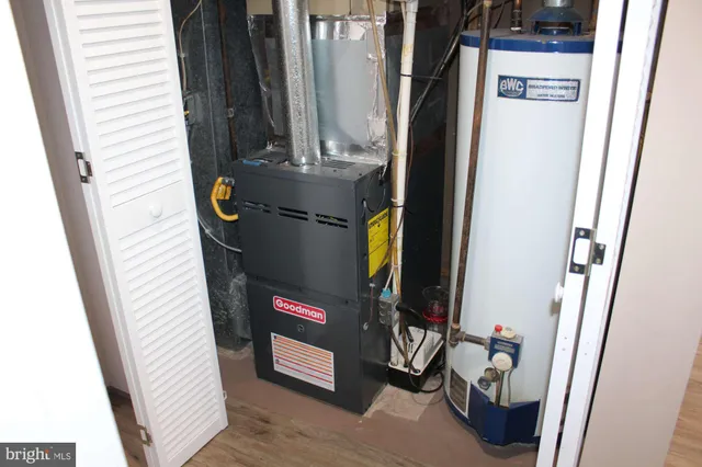 a view of a hallway with wooden cabinets and staircase