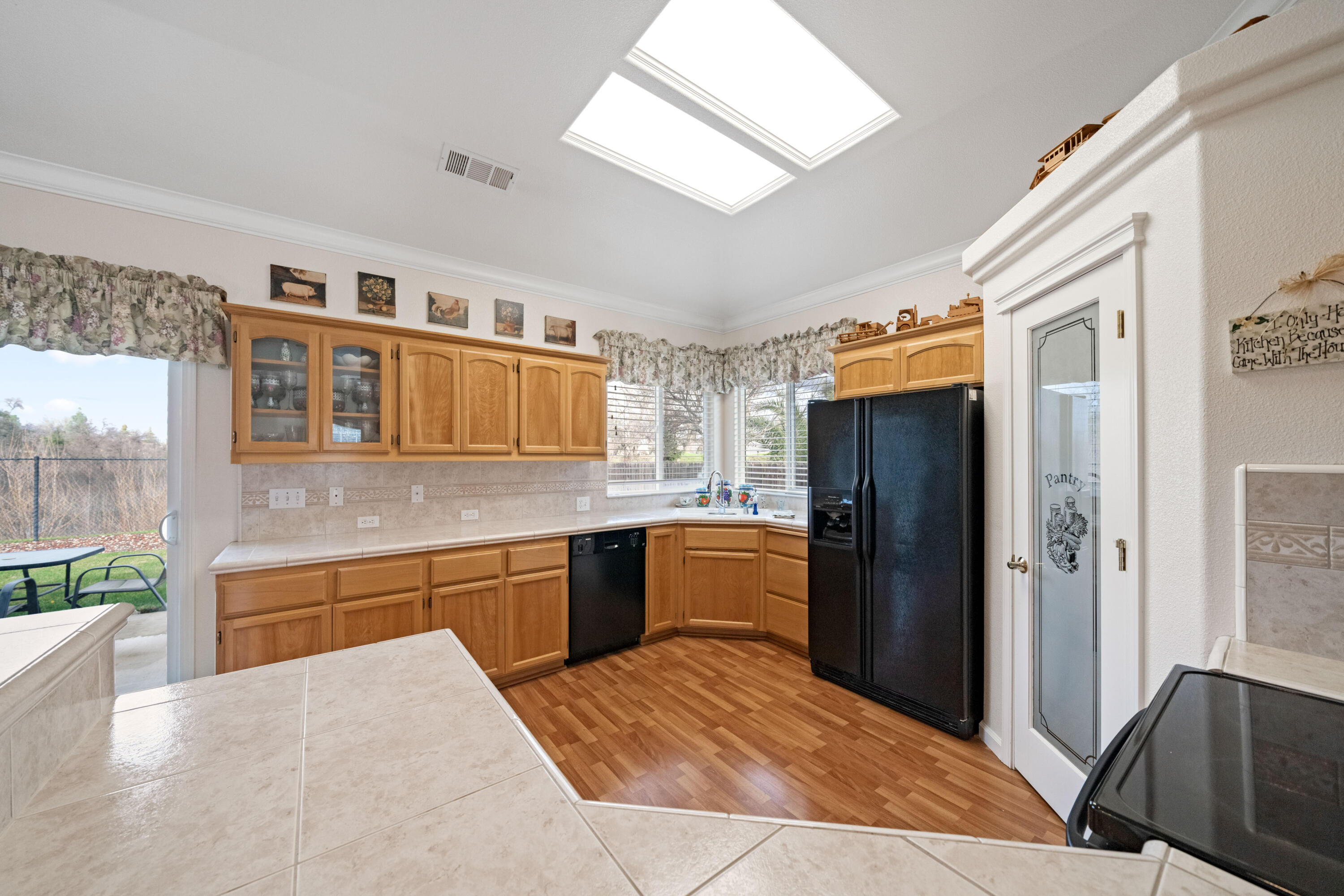 2662 Queens Way Redding, CA 96001 - Photo 3 of 21 a kitchen with stainless steel appliances kitchen island granite countertop a refrigerator and a sink