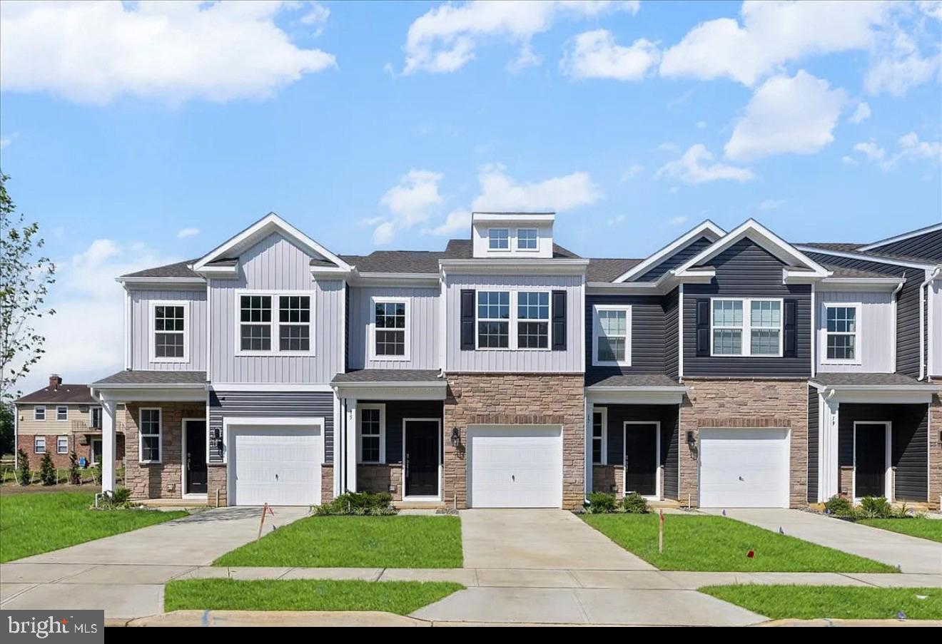 a front view of a house with a yard and trees