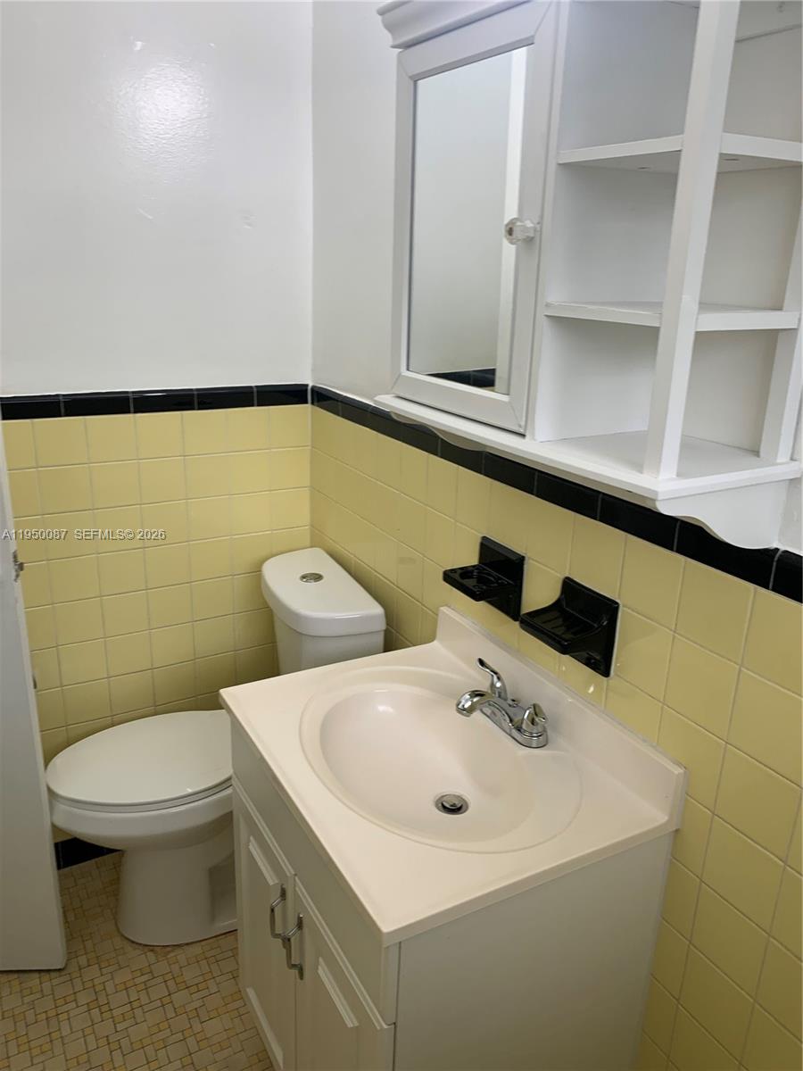 5616 Arthur Street, Unit NORTH Hollywood, FL 33021 - Photo 13 of 16 a bathroom with a sink a toilet and mirror