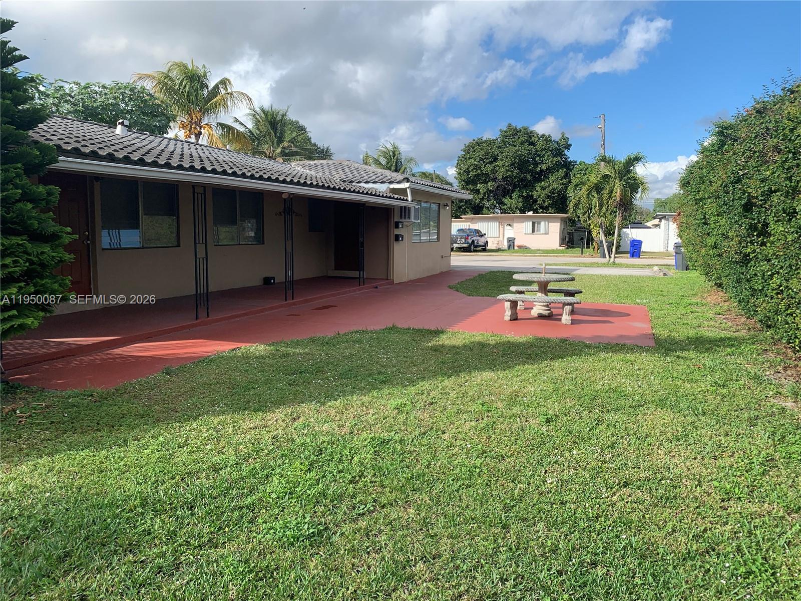 5616 Arthur Street, Unit NORTH Hollywood, FL 33021 - Photo 16 of 16 an outdoor space with lots of green space and plants