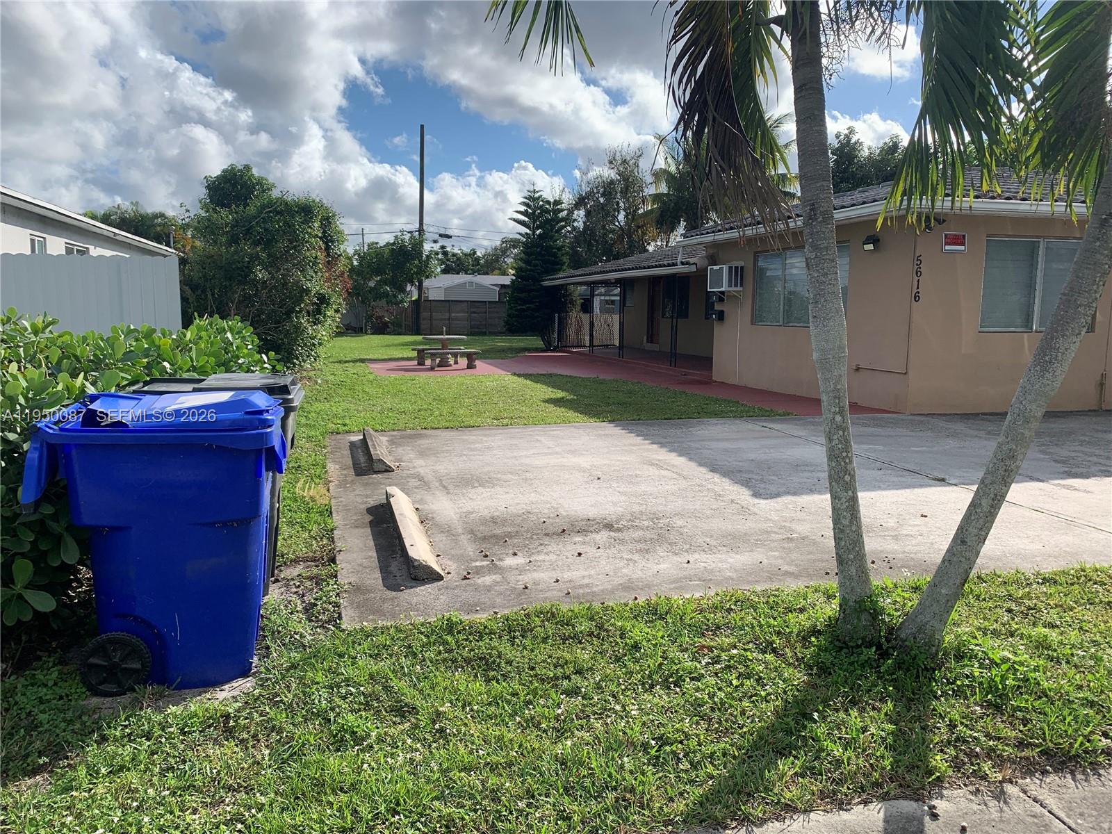 5616 Arthur Street, Unit NORTH Hollywood, FL 33021 - Photo 2 of 16 a view of a backyard with potted plants