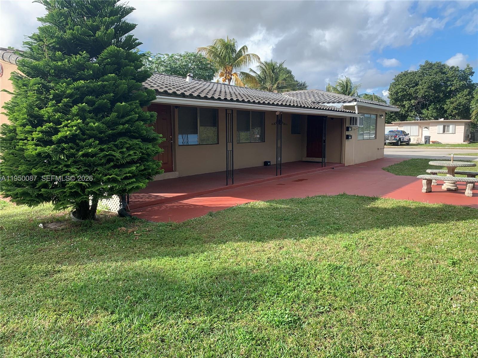 5616 Arthur Street, Unit NORTH Hollywood, FL 33021 - Photo 3 of 16 a view of a house with a yard porch and sitting area
