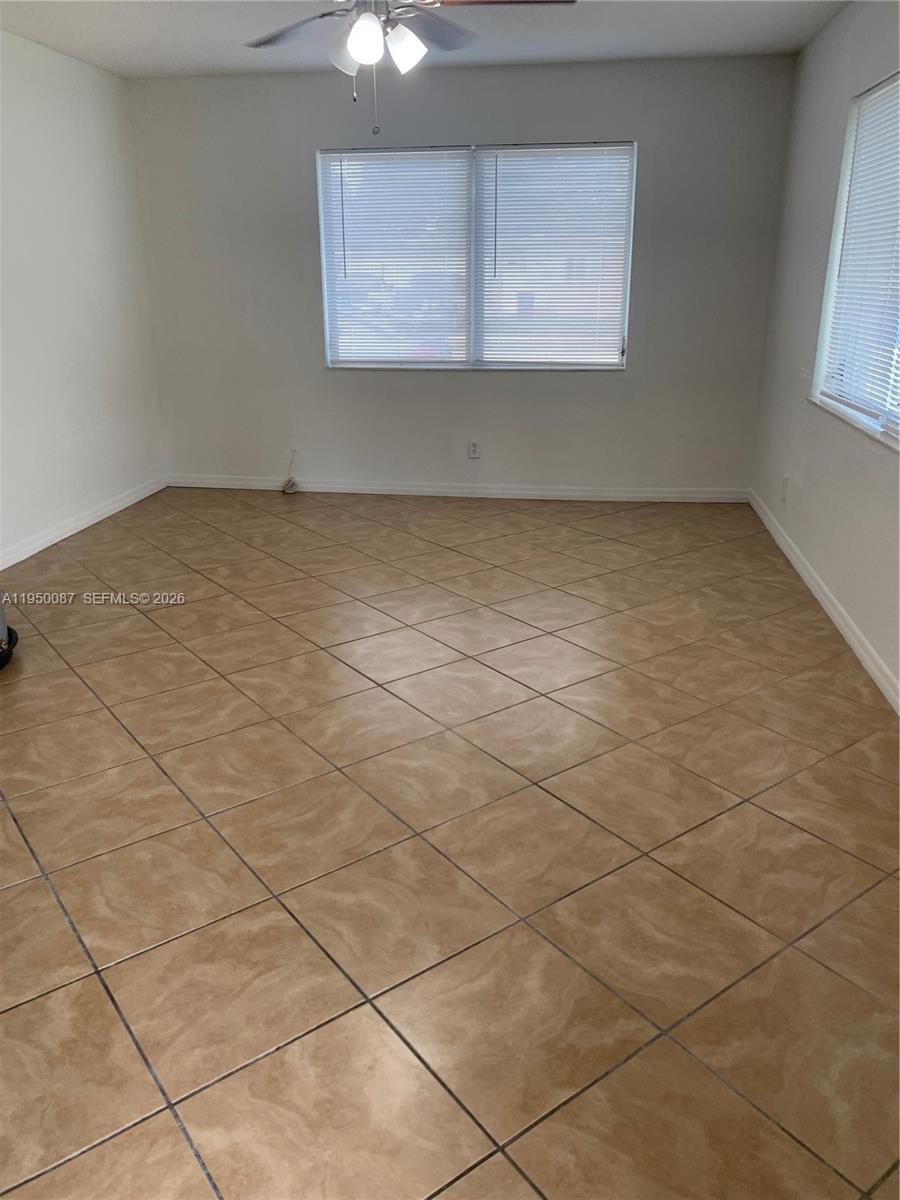 5616 Arthur Street, Unit NORTH Hollywood, FL 33021 - Photo 5 of 16 an empty room with windows