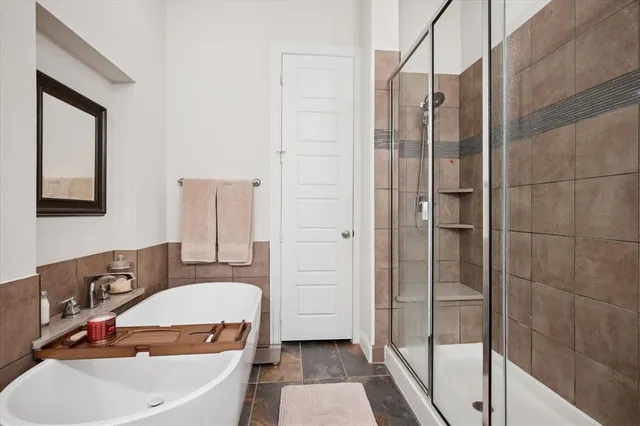 a bathroom with a tub sink and mirror