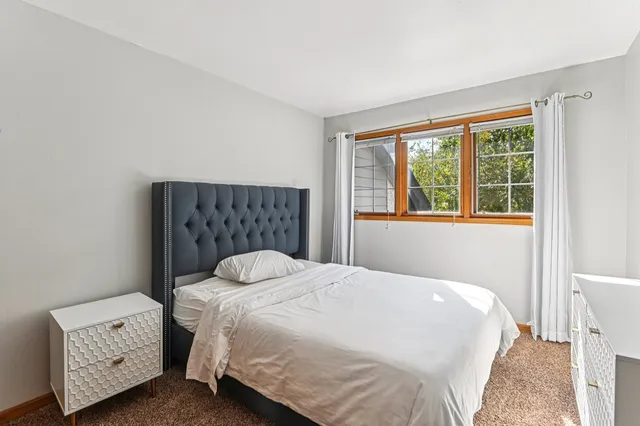 a bedroom with a bed and window