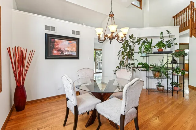 a view of a dining room with furniture wooden floor and a chandelier