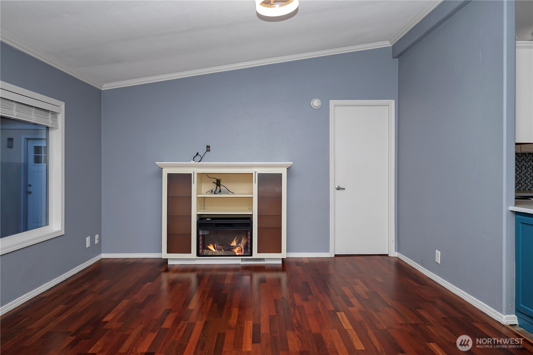 15253 Pine Drive Renton, WA 98058 - Photo 3 of 28 an empty room with wooden floor a fireplace and window