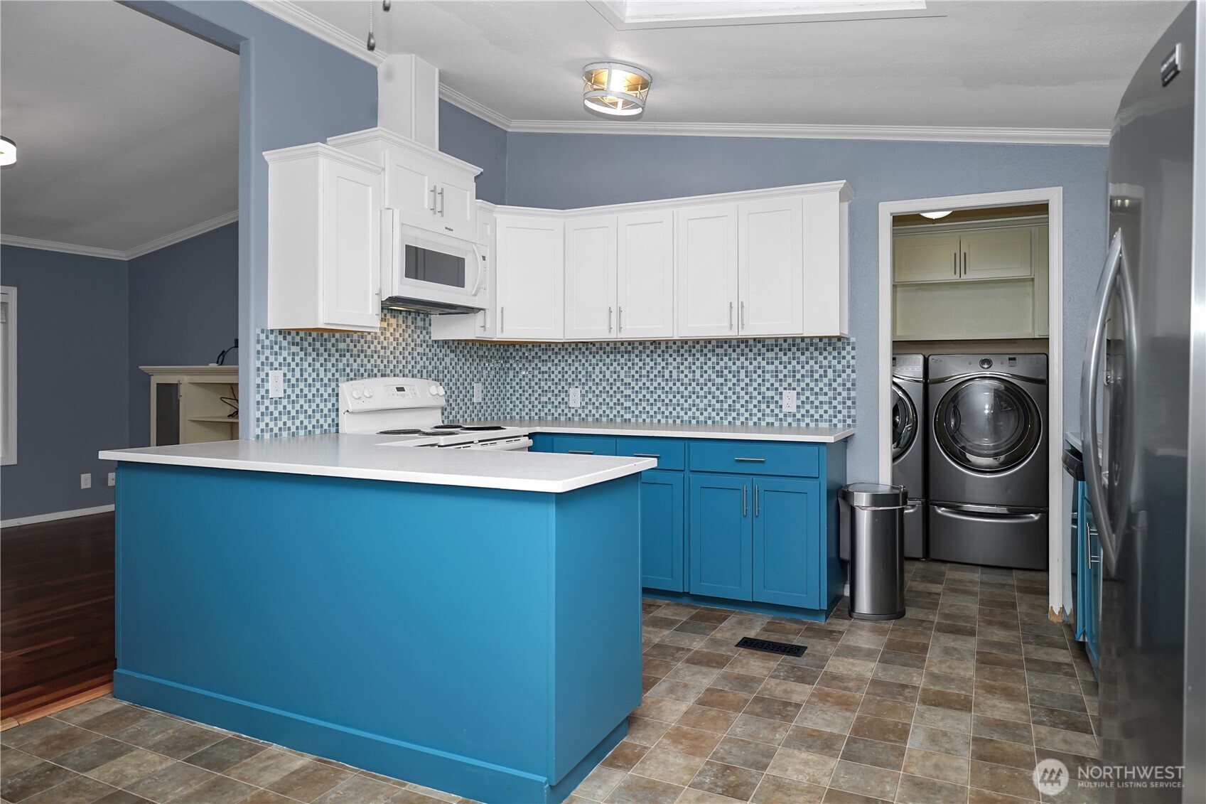 15253 Pine Drive Renton, WA 98058 - Photo 7 of 28 a kitchen with a sink a stove and cabinets