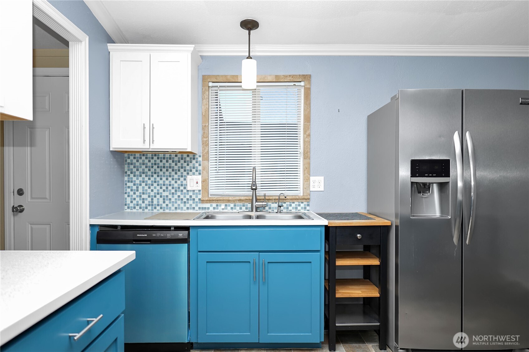 15253 Pine Drive Renton, WA 98058 - Photo 9 of 28 a kitchen with a sink and refrigerator