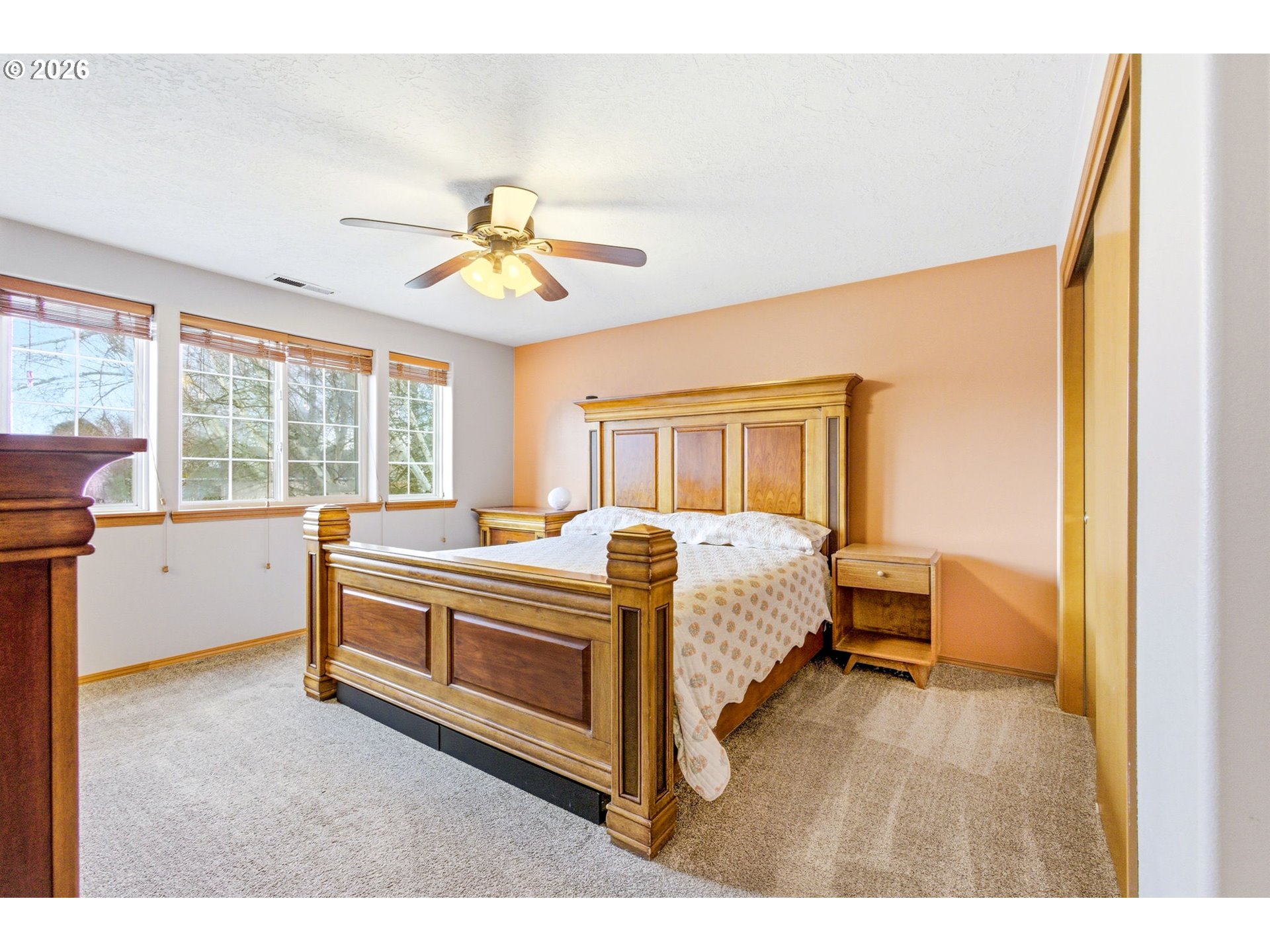 4820 Rebecca Street Northeast Salem, OR 97305 - Photo 15 of 30 a spacious bedroom with a bed and a chandelier