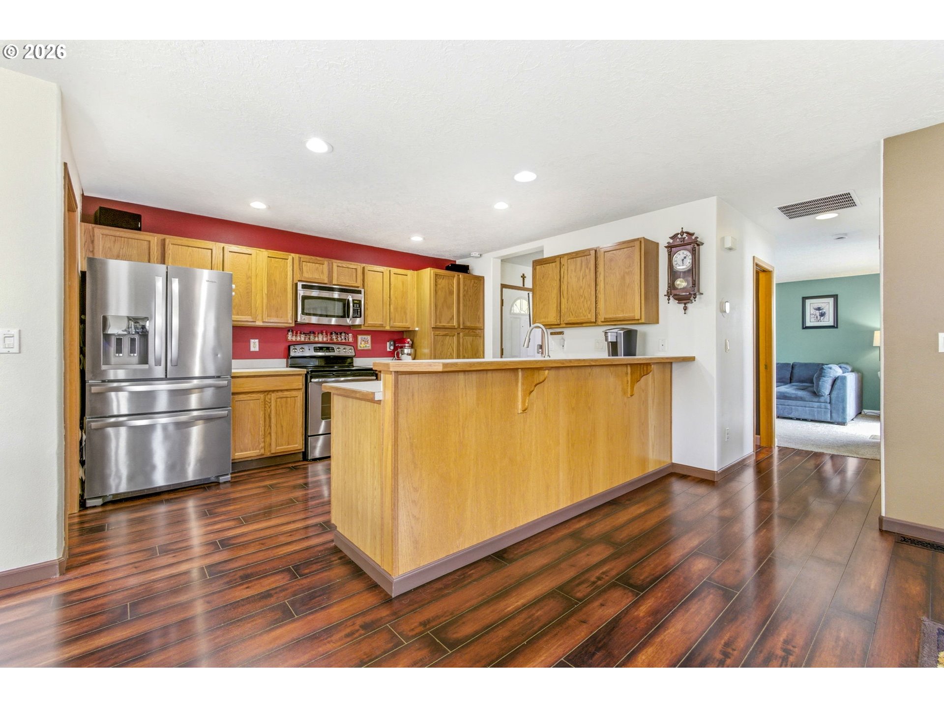 4820 Rebecca Street Northeast Salem, OR 97305 - Photo 10 of 30 a kitchen with stainless steel appliances a refrigerator and wooden floor