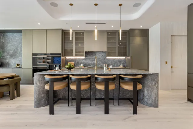 a kitchen with stainless steel appliances granite countertop sink stove and wooden floor