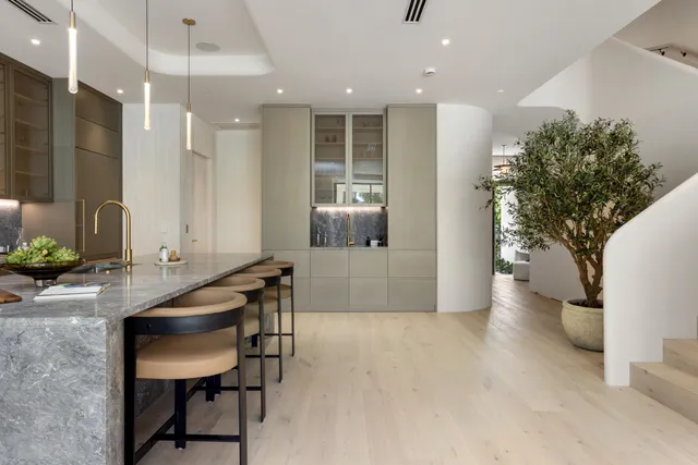 a living room with furniture and kitchen view