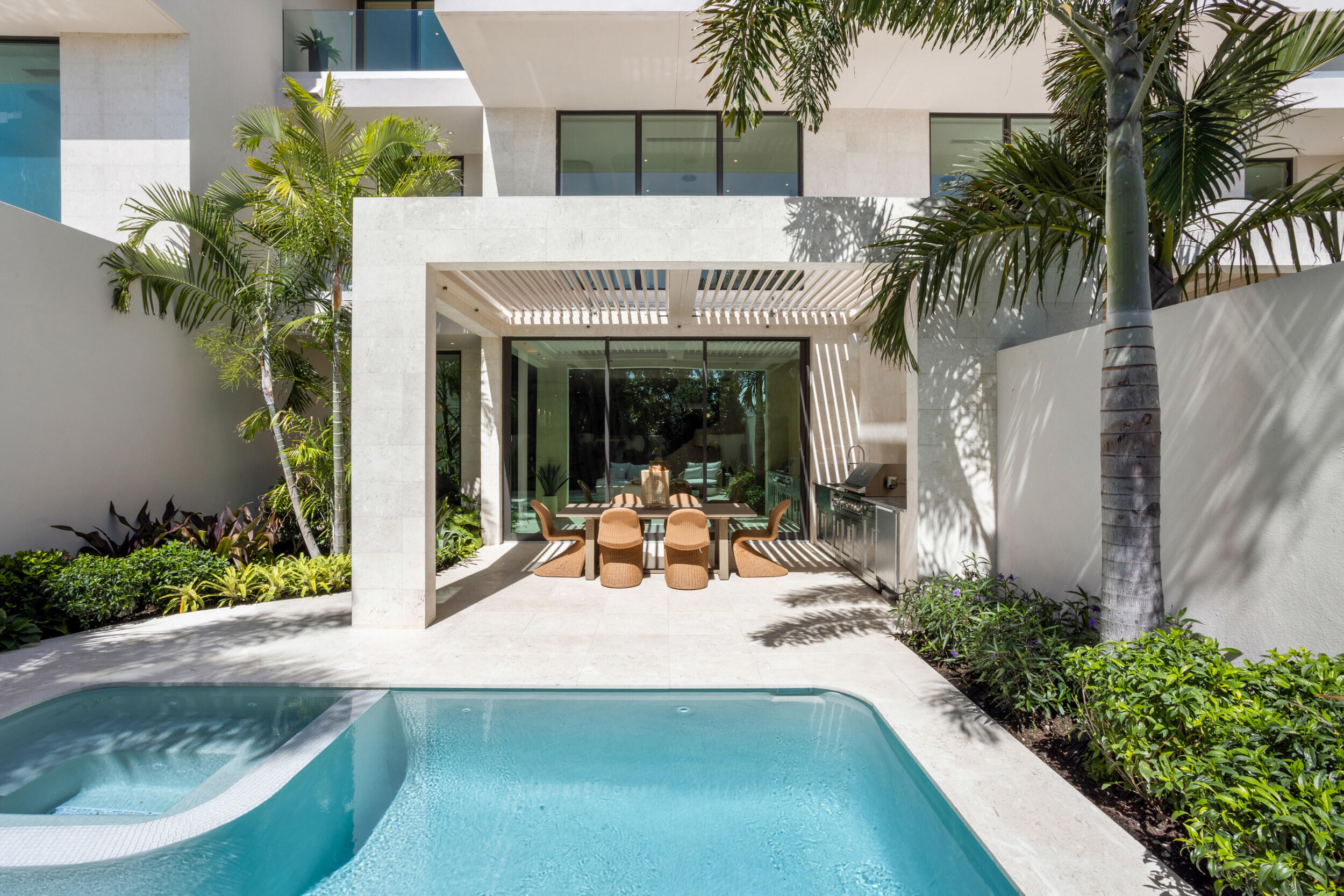 1252 George Bush Boulevard Delray Beach, FL 33483 - Photo 21 of 63 a view of a patio with table and chairs and potted plants