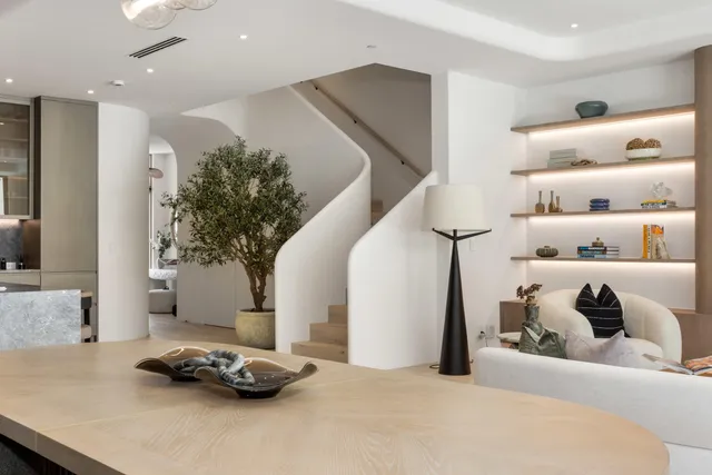 a bathroom with a tub a sink and mirror